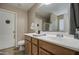 Bright bathroom with double sinks, wooden cabinets and large mirrors creating functional space at 1259 E Canyon Trl, San Tan Valley, AZ 85143