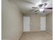 This lovely bedroom features neutral walls, a ceiling fan, and two white doors at 1259 E Canyon Trl, San Tan Valley, AZ 85143