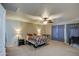 Large primary bedroom with a ceiling fan and patterned curtains for a restful retreat at 1259 E Canyon Trl, San Tan Valley, AZ 85143