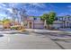 Exterior shot of tan two-story home with desert landscaping and a long driveway at 1259 E Canyon Trl, San Tan Valley, AZ 85143