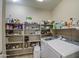 This functional laundry room includes shelving and newer model washer and dryer at 1259 E Canyon Trl, San Tan Valley, AZ 85143