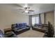 Living room featuring comfortable sofas, a ceiling fan, natural lighting, and a carpeted floor at 1259 E Canyon Trl, San Tan Valley, AZ 85143