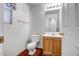 Clean bathroom with wood vanity and neutral color scheme at 14210 N 135Th Dr, Surprise, AZ 85379