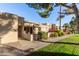 Tan stucco condo building with walkway, landscaping, and patio at 14300 W Bell Rd # 207, Surprise, AZ 85374