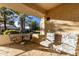 Patio with table, chairs, and umbrella; view of trees at 14300 W Bell Rd # 207, Surprise, AZ 85374