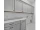 Bright laundry room with gray cabinets and quartz countertop at 14846 E Valley Vista Dr, Fountain Hills, AZ 85268