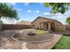 Landscaped backyard with a fire pit at 15325 W Port Au Prince Ln, Surprise, AZ 85379