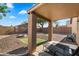 Covered patio, fire pit, and gravel backyard at 15325 W Port Au Prince Ln, Surprise, AZ 85379