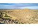 Aerial view of a community near a large mountain and golf course at 157 W Latigo Cir, San Tan Valley, AZ 85143