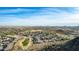 Expansive aerial view of a community with a golf course and scenic mountain backdrop at 157 W Latigo Cir, San Tan Valley, AZ 85143