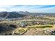 Aerial view of a community with club house, golf course, and desert landscape at 157 W Latigo Cir, San Tan Valley, AZ 85143