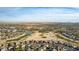 Wide aerial view of a sprawling community featuring a golf course and residential homes at 157 W Latigo Cir, San Tan Valley, AZ 85143