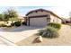 House exterior showcasing a two-car garage and desert landscaping at 157 W Latigo Cir, San Tan Valley, AZ 85143