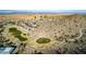 Aerial view of community golf course and surrounding landscape at 157 W Latigo Cir, San Tan Valley, AZ 85143