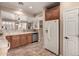 Modern kitchen with wood cabinets, tile floors, and stainless steel appliances at 157 W Latigo Cir, San Tan Valley, AZ 85143