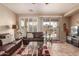 Spacious living room with leather couches and glass coffee table at 157 W Latigo Cir, San Tan Valley, AZ 85143