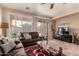 Living room featuring leather furniture, a large TV, and patio access at 157 W Latigo Cir, San Tan Valley, AZ 85143