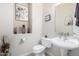 Clean bathroom with a pedestal sink and a built-in niche at 1603 E Zion Way, Chandler, AZ 85249