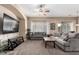 Living room with grey sectional sofa, large TV, and coffee table at 1603 E Zion Way, Chandler, AZ 85249