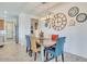 Bright dining room with a rustic wood table and unique clock decor at 16789 S 181St Ln, Goodyear, AZ 85338