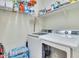 Laundry room with washer, dryer, and shelving at 16789 S 181St Ln, Goodyear, AZ 85338