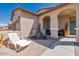 Covered patio with seating area, adjacent to the home's entrance at 16789 S 181St Ln, Goodyear, AZ 85338