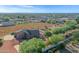 Aerial view of house, large lot, and distant cityscape at 17642 E Hunt Hwy, Queen Creek, AZ 85142