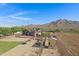 Aerial view showcasing house, garden, and mountain backdrop at 17642 E Hunt Hwy, Queen Creek, AZ 85142