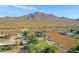 Aerial view of a house with a large yard and mountain backdrop at 17642 E Hunt Hwy, Queen Creek, AZ 85142