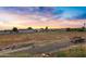 Large lot with farmland, a truck, and distant homes at 17642 E Hunt Hwy, Queen Creek, AZ 85142