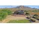 Aerial view of house with garden, and mountain background at 17642 E Hunt Hwy, Queen Creek, AZ 85142