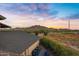 Scenic backyard view with mountain backdrop at sunset at 17642 E Hunt Hwy, Queen Creek, AZ 85142