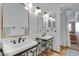 Bathroom with double vanity, tile floors, and large mirrors at 17642 E Hunt Hwy, Queen Creek, AZ 85142