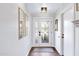 Bright entryway with wood floors, mirrors, and a modern glass door at 17642 E Hunt Hwy, Queen Creek, AZ 85142