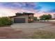 Two-story house with a large driveway and desert landscaping at 17642 E Hunt Hwy, Queen Creek, AZ 85142