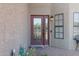 Inviting front entry with red door and brick patio at 17642 E Hunt Hwy, Queen Creek, AZ 85142