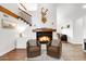 Cozy living room with a fireplace and hardwood floors at 17642 E Hunt Hwy, Queen Creek, AZ 85142