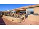 Backyard with covered patio, outdoor kitchen, and gravel landscaping at 17721 N Canal Dr, Surprise, AZ 85374