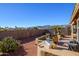 Spacious backyard patio with seating area, fire pit, and mountain views at 17721 N Canal Dr, Surprise, AZ 85374