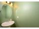 Small bathroom with pedestal sink and oval mirror at 17721 N Canal Dr, Surprise, AZ 85374