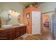 Double vanity bathroom with granite countertop and glass block shower at 17721 N Canal Dr, Surprise, AZ 85374