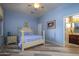 Bright bedroom with a light-blue color scheme, featuring a post bed and built-in dresser at 17721 N Canal Dr, Surprise, AZ 85374