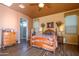 Main bedroom with wood floors, ensuite bath access, and ceiling fan at 17721 N Canal Dr, Surprise, AZ 85374