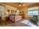 Spacious bedroom with wood flooring and a ceiling fan at 17721 N Canal Dr, Surprise, AZ 85374