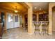 Elegant entryway with tile flooring, arched entry, and a wet bar at 17721 N Canal Dr, Surprise, AZ 85374