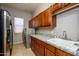 Laundry room with stainless steel appliances and wood cabinets at 17721 N Canal Dr, Surprise, AZ 85374