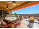 Covered patio with outdoor seating, fire pit, and ceiling fans at 17721 N Canal Dr, Surprise, AZ 85374