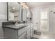 Bathroom with dual sinks, gray vanity, and large mirrors at 17811 N Boswell Blvd, Sun City, AZ 85373