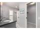 Elegant bathroom with dual vanities, gray counters, and a walk-in shower at 17811 N Boswell Blvd, Sun City, AZ 85373