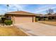 Tan brick home with attached garage and well-manicured lawn at 17811 N Boswell Blvd, Sun City, AZ 85373